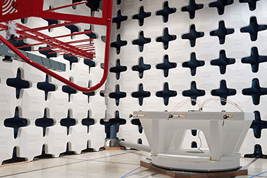 Anechoic EMC chamber with absorber-lined walls and a test antenna